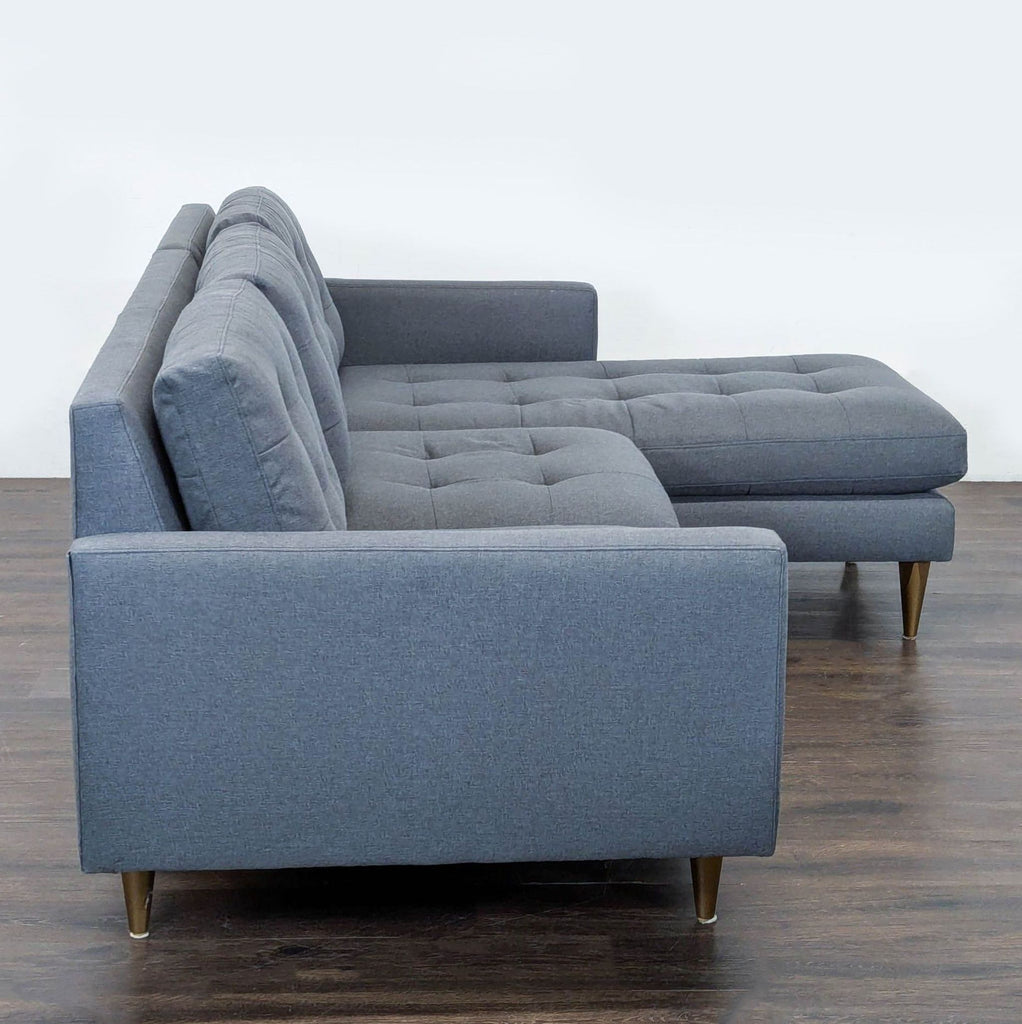 Contemporary Crate & Barrel sofa in gray fabric with right-facing chaise, comfortable tufted cushions, and sleek legs.