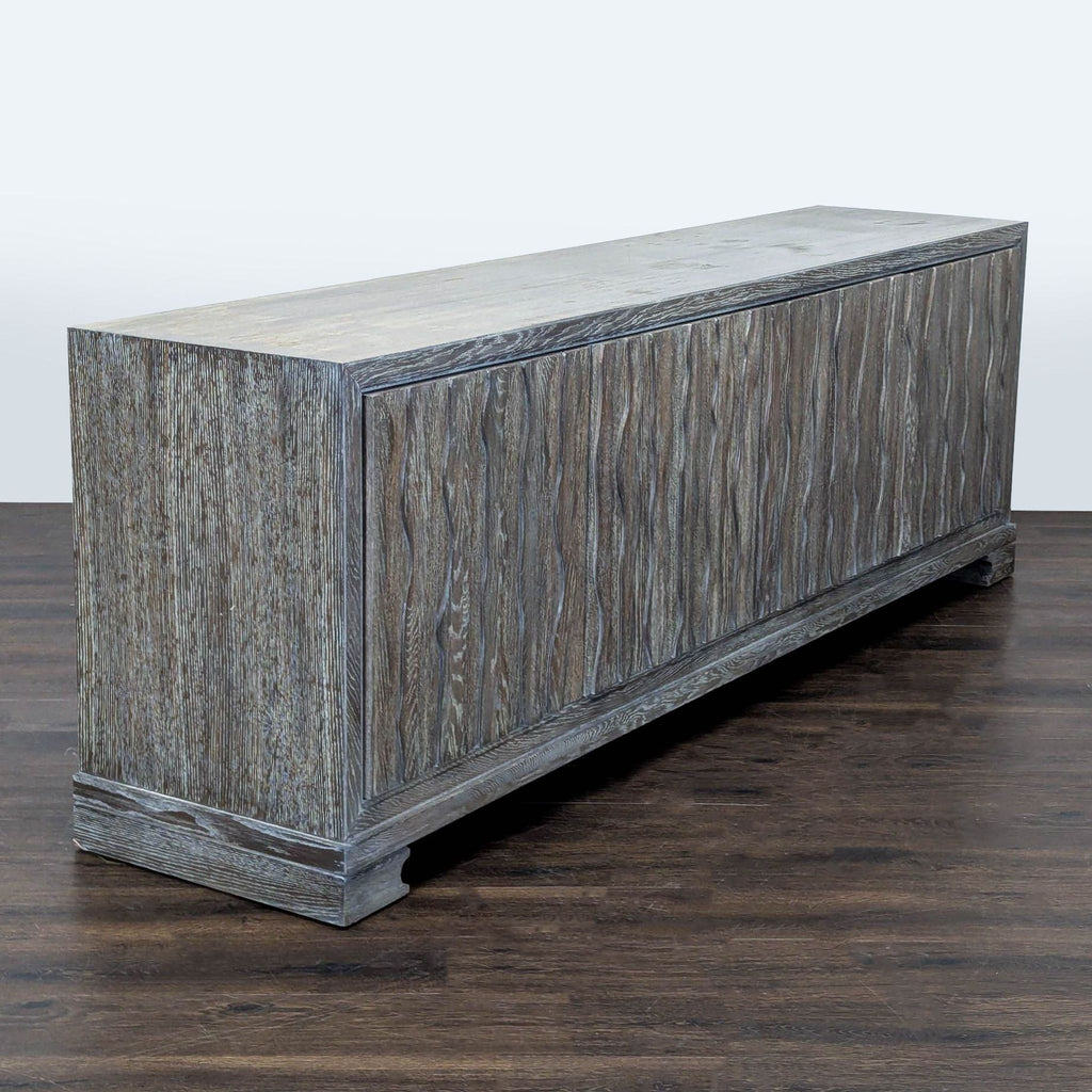 Gray washed Vanguard Furniture media console with artistic sculpted doors, perfect for living spaces.