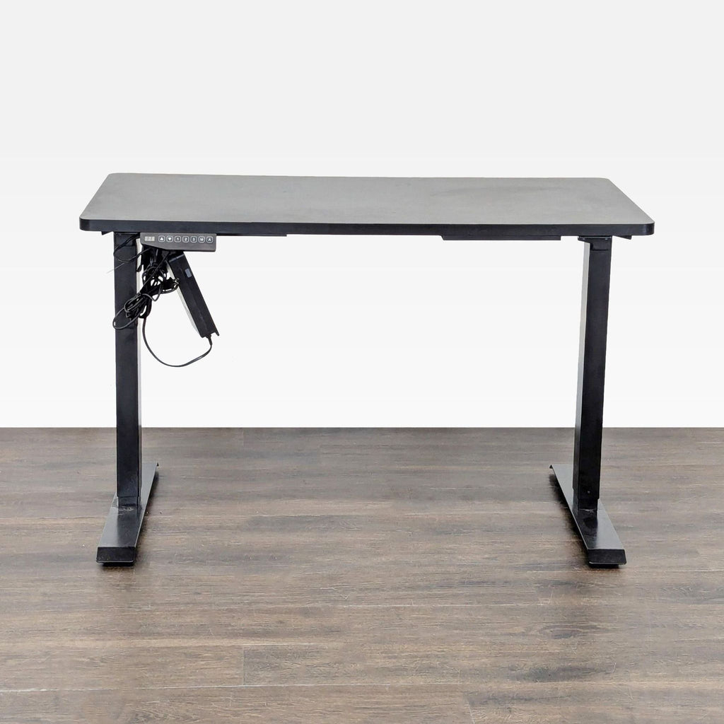 Flexispot electric desk with black tabletop, sturdy metal legs, and height-adjustment control panel for versatile use.  