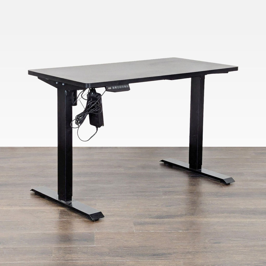 Modern Flexispot sit-stand desk featuring an easy electric lift system, spacious black surface, and metal frame.  