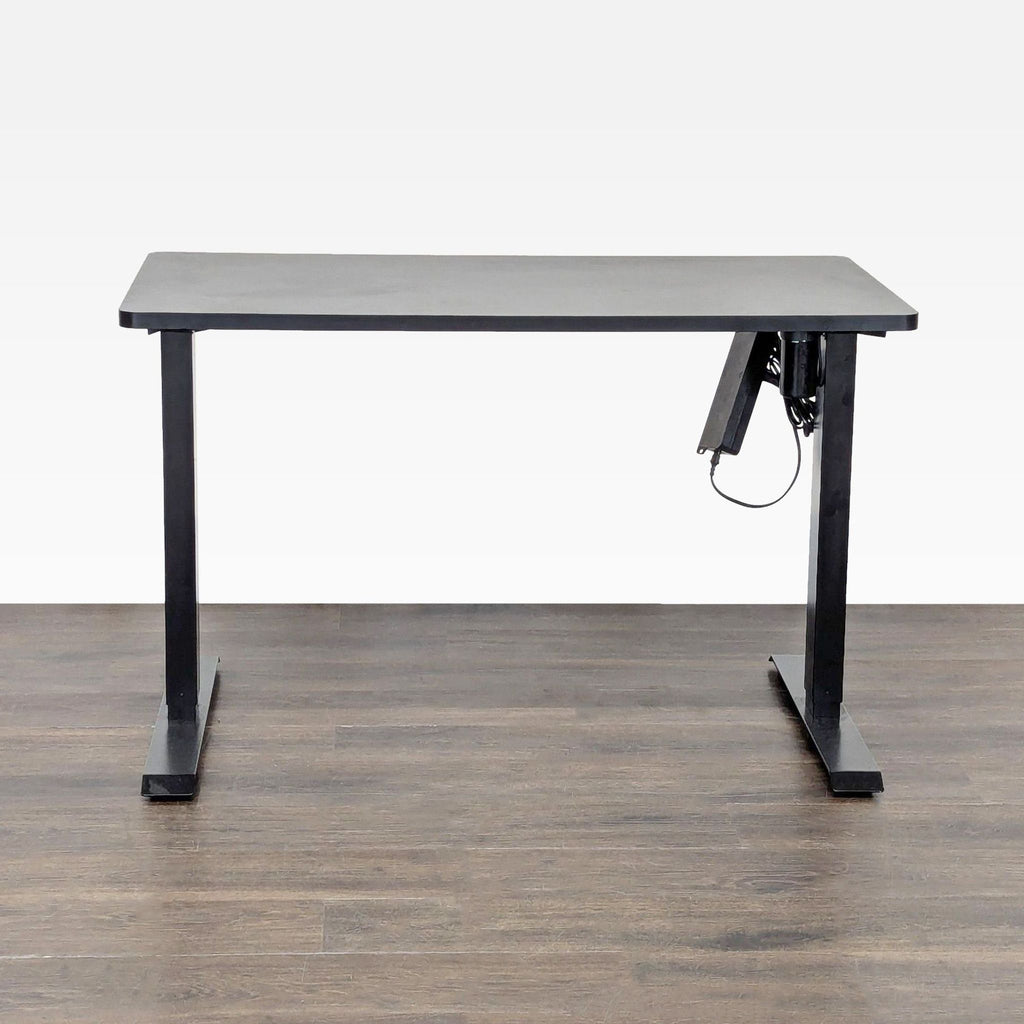 Spacious black Flexispot desk with electric height adjustment, ideal for contemporary offices or ergonomic workspaces.