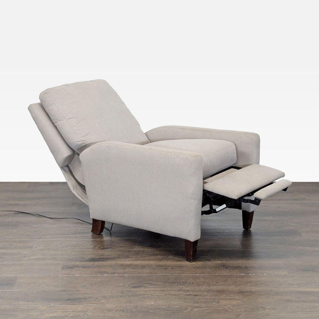 Sleek reclining lounge chair featuring soft padding, supportive armrests, and a modern design for comfort.