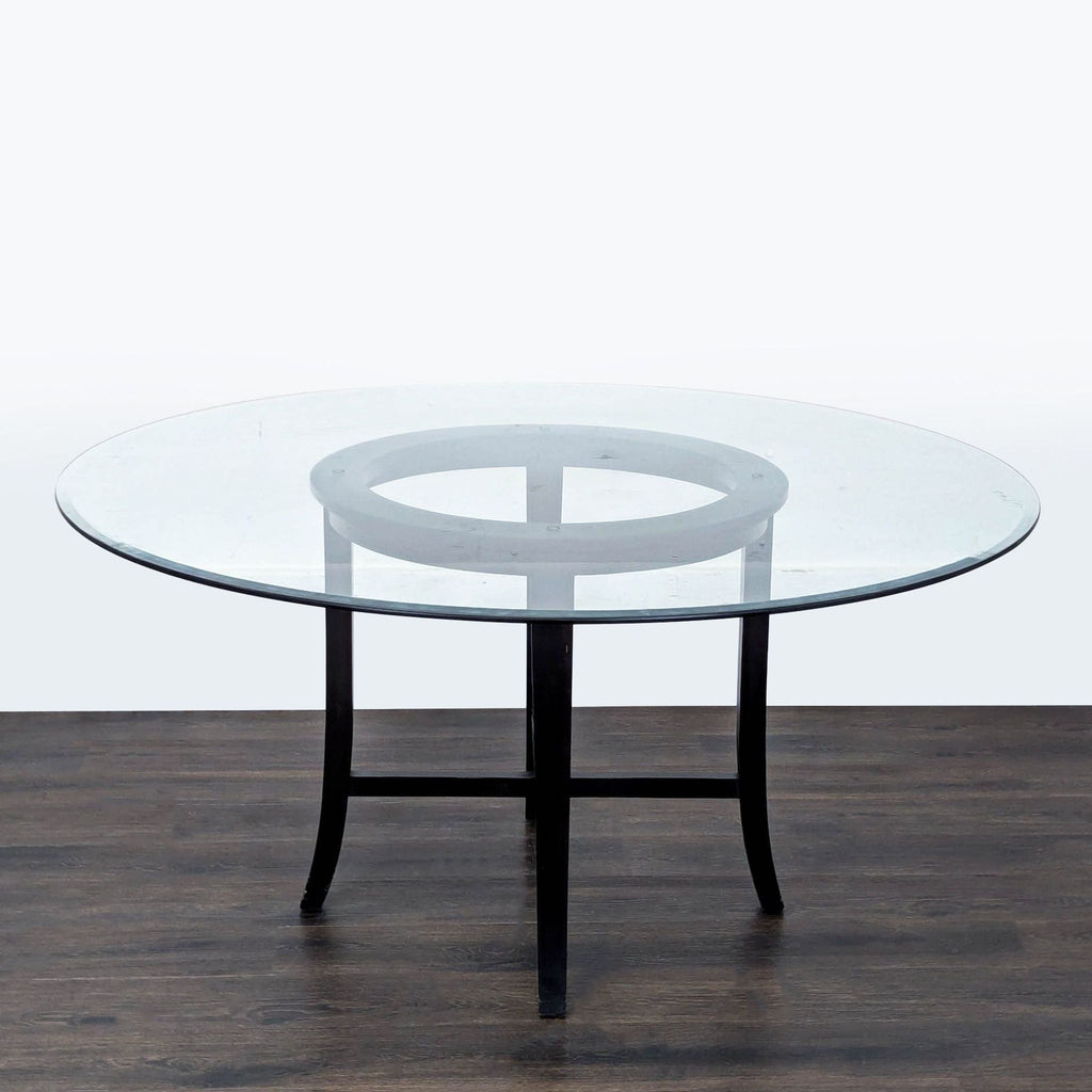 3. Contemporary round glass dining table with black curved legs, set against a neutral background.