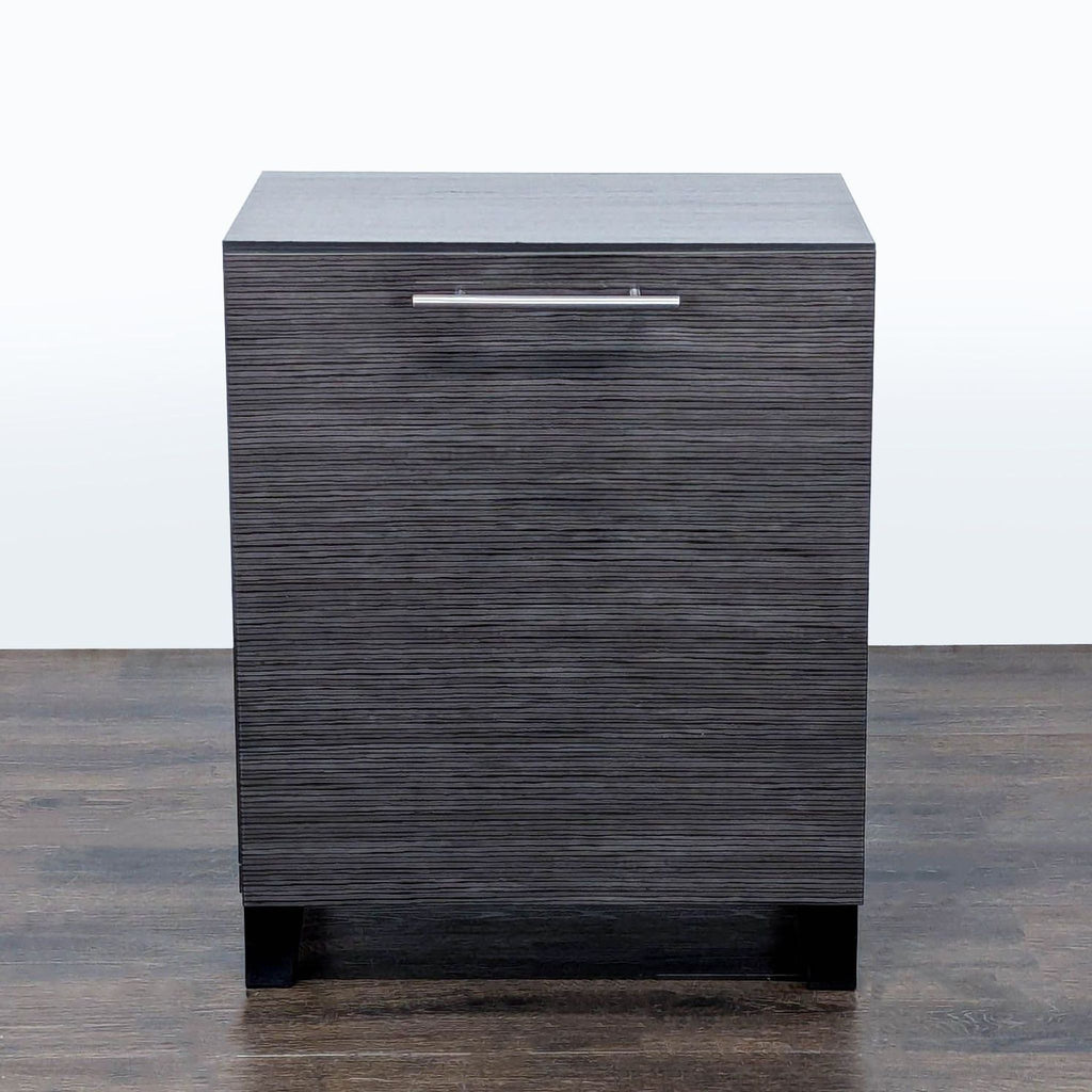 1. Dark wood cabinet with textured front and metal handle, shown on a wood floor against white background.
