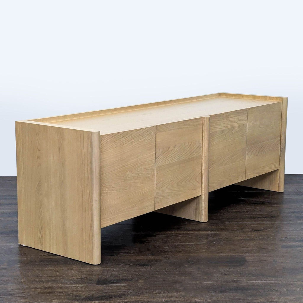 Modern entertainment center in white oak with solid and veneered wood, rounded legs, and adjustable shelving.