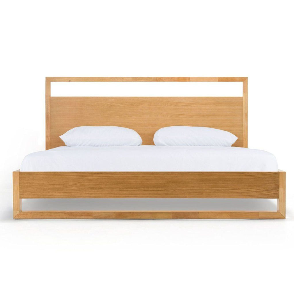 Nova Domus bed with warm wood veneer, minimalist headboard with open detail, and Parsons-style legs.