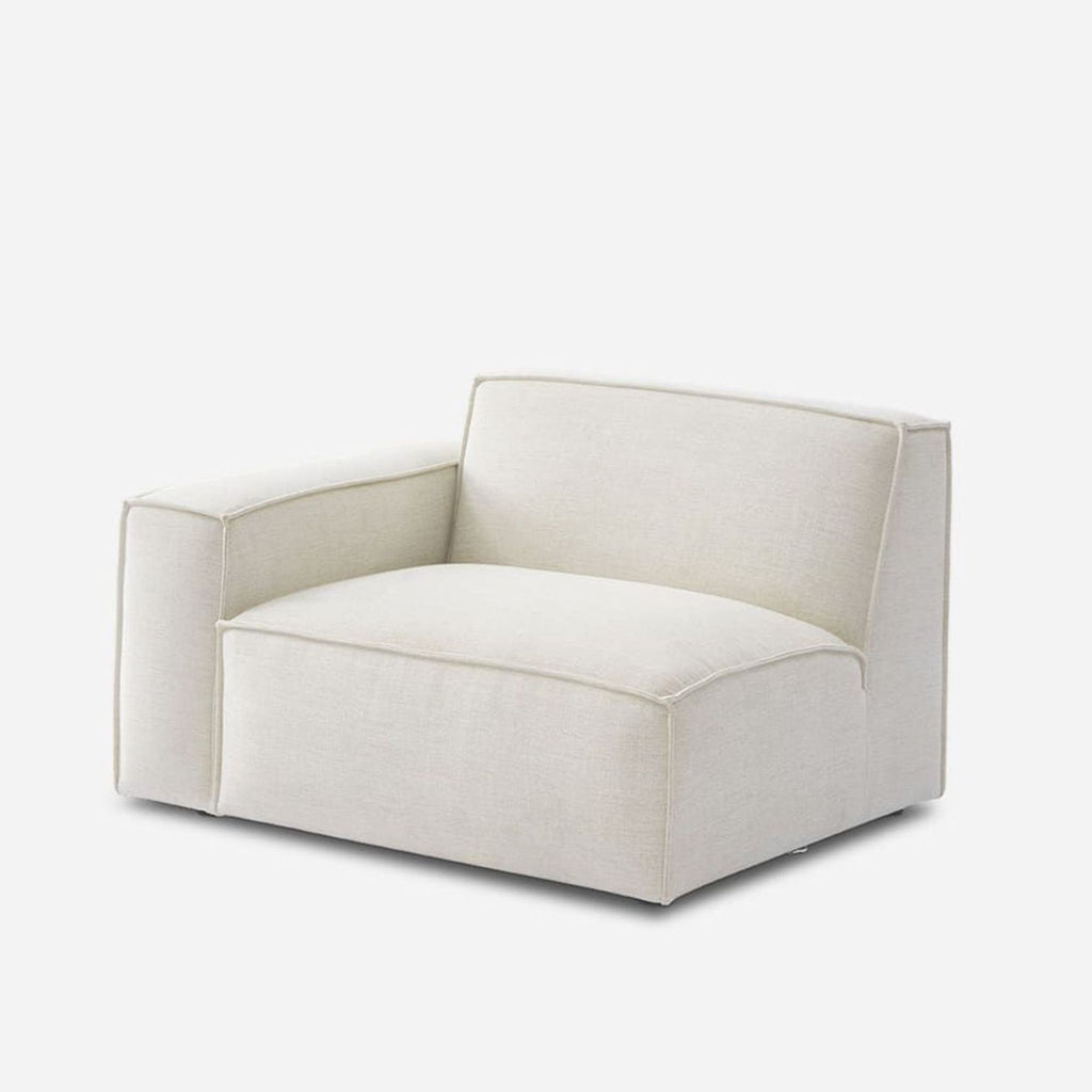 Contemporary low-profile Castlery chair in soft white, featuring a single wide left arm and plush cushion.  