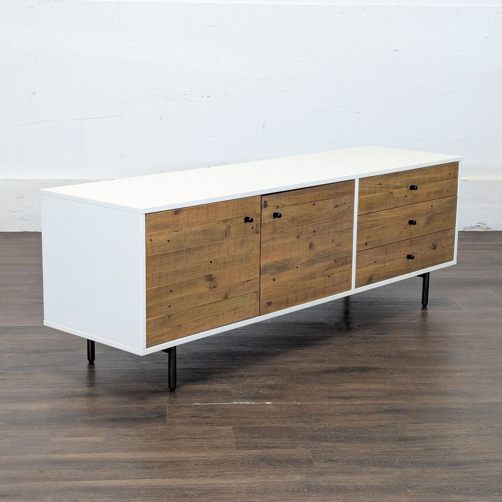 3. Angled side view of mid-century style West Elm media console with wood doors and drawer fronts.