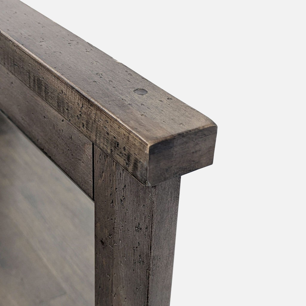 3. Close-up of the corner joinery on a rustic wood-framed Vaughan-Bassett mirror in a stone grey finish.
