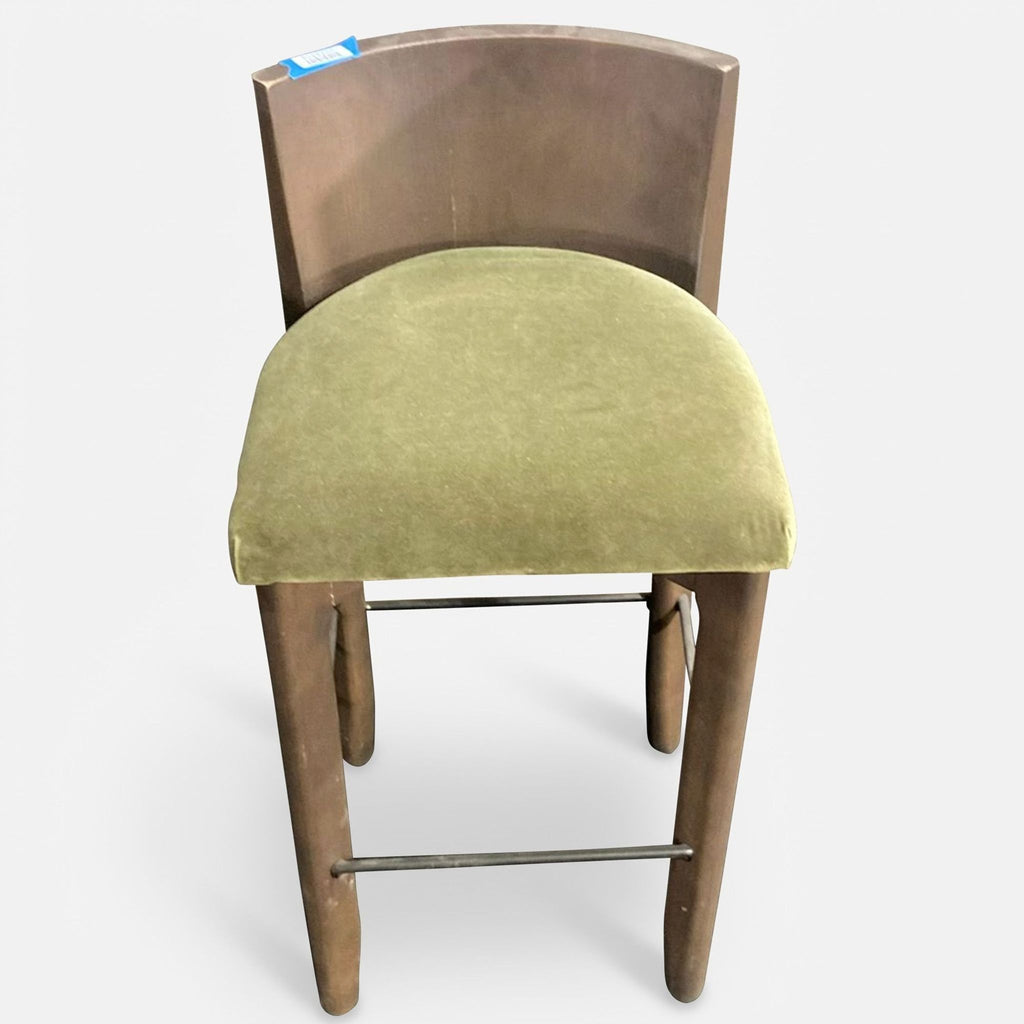 Single Delancey bar stool by Maiden Home, showing ash wood frame, curved back, green cushion, and metal footrest.
