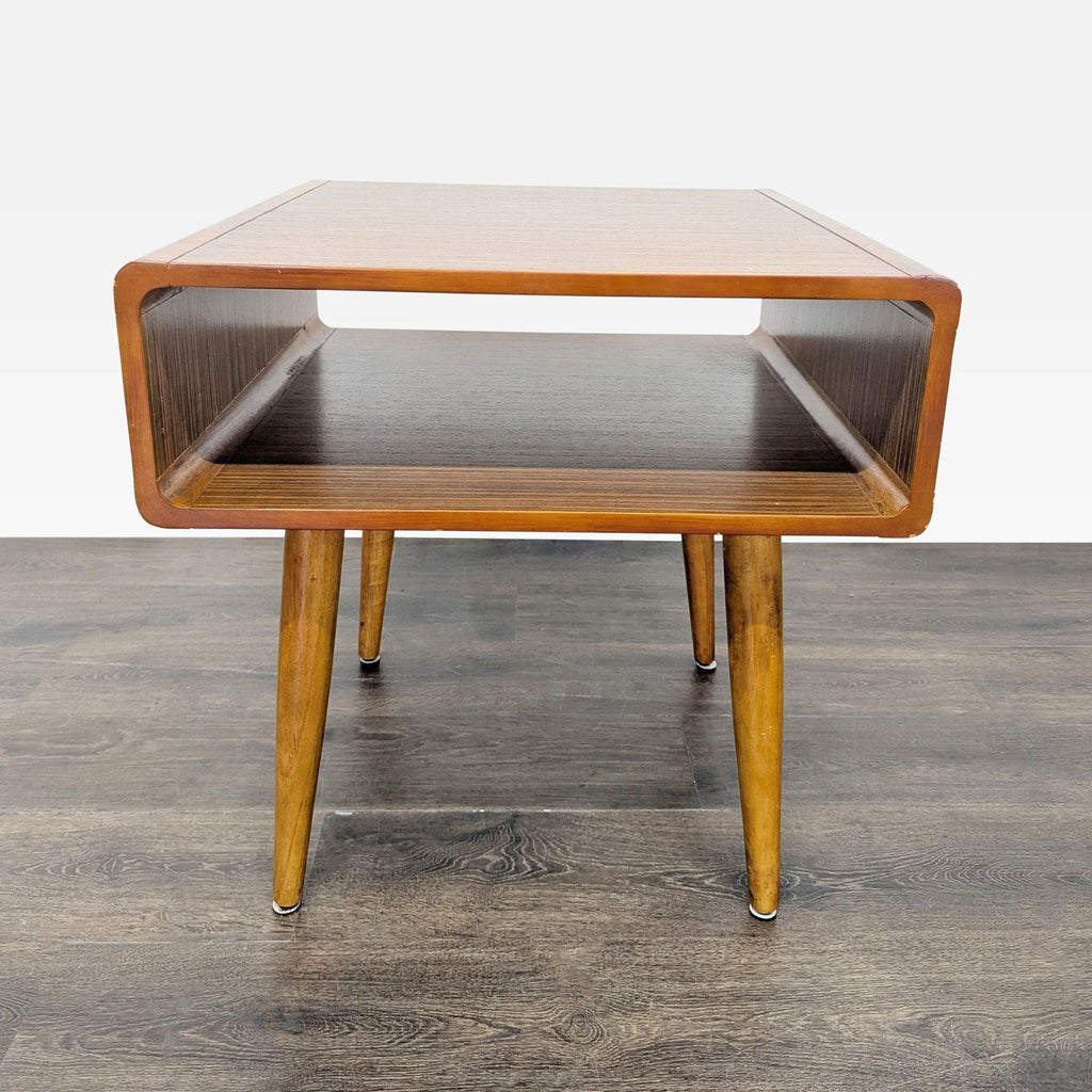 3. Front view of a retro end table featuring a rectangular open compartment and four angled wood legs.