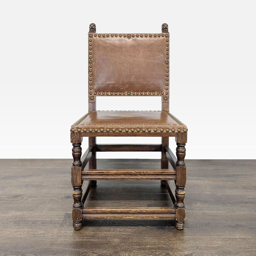 Dining chair with carved finials and nailhead trim, featuring a classic design.  