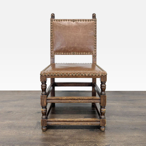 Dining chair featuring carved finials and decorative nailhead trim along the edges.  