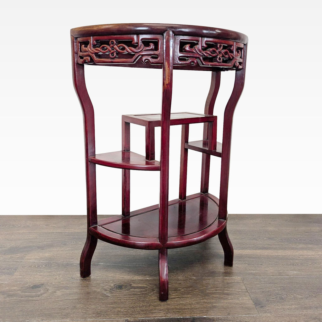 Elegant demilune stand for side or console use, showcasing three storage tiers and a carved apron.