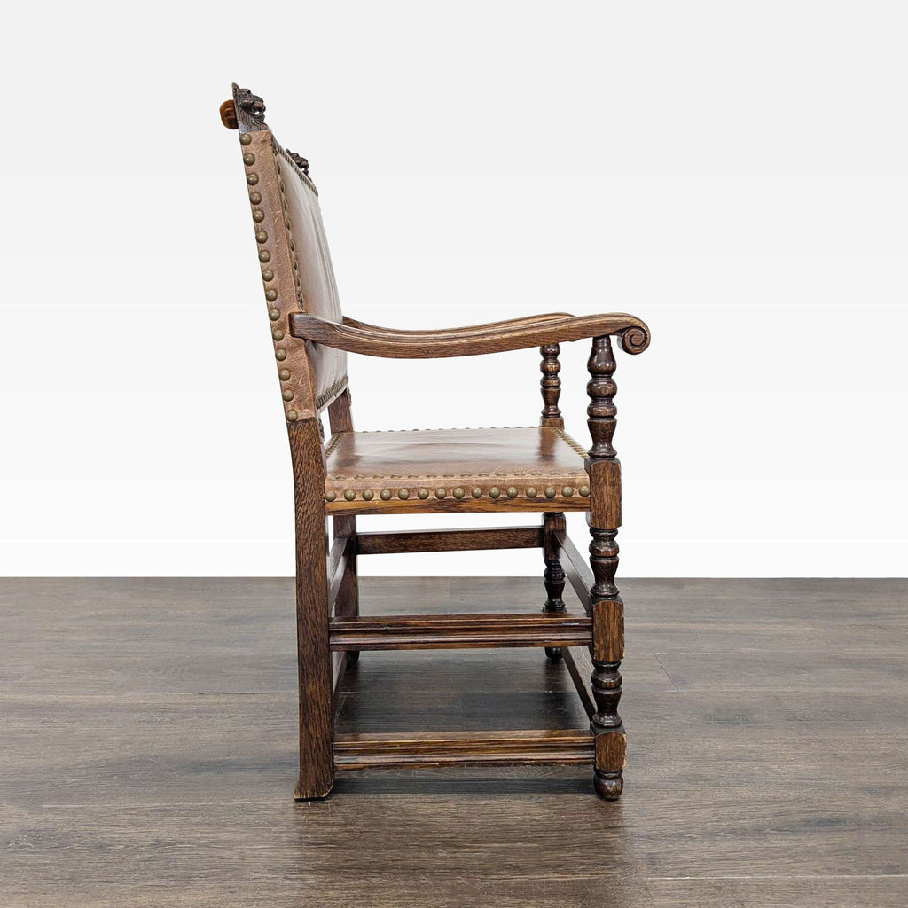 Elegant dining chair featuring ornate finials atop the backrest and classic nailhead border accents.