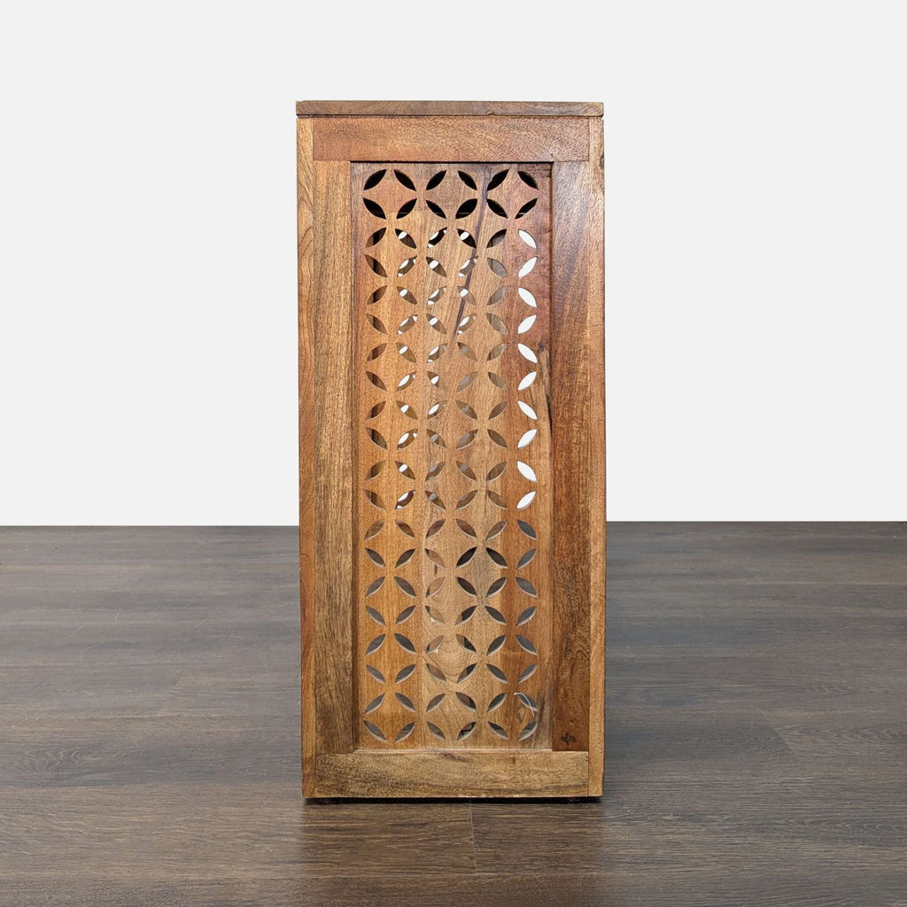 3. End view of a wooden console table highlighting its detailed floral-patterned cutout side panel.