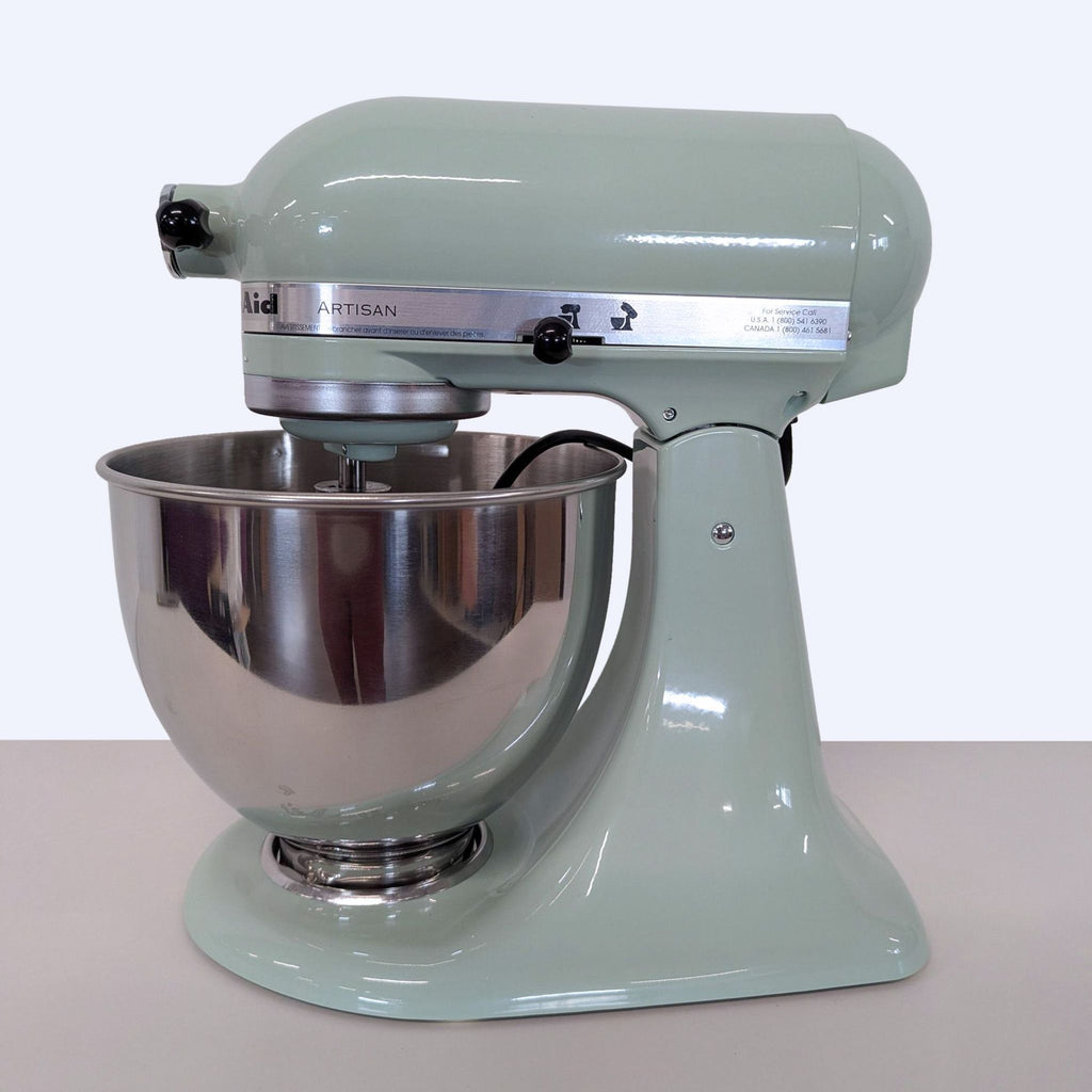 Stylish mint green KitchenAid mixer with a sturdy handle and bowl, suitable for both beginner and pro cooks.