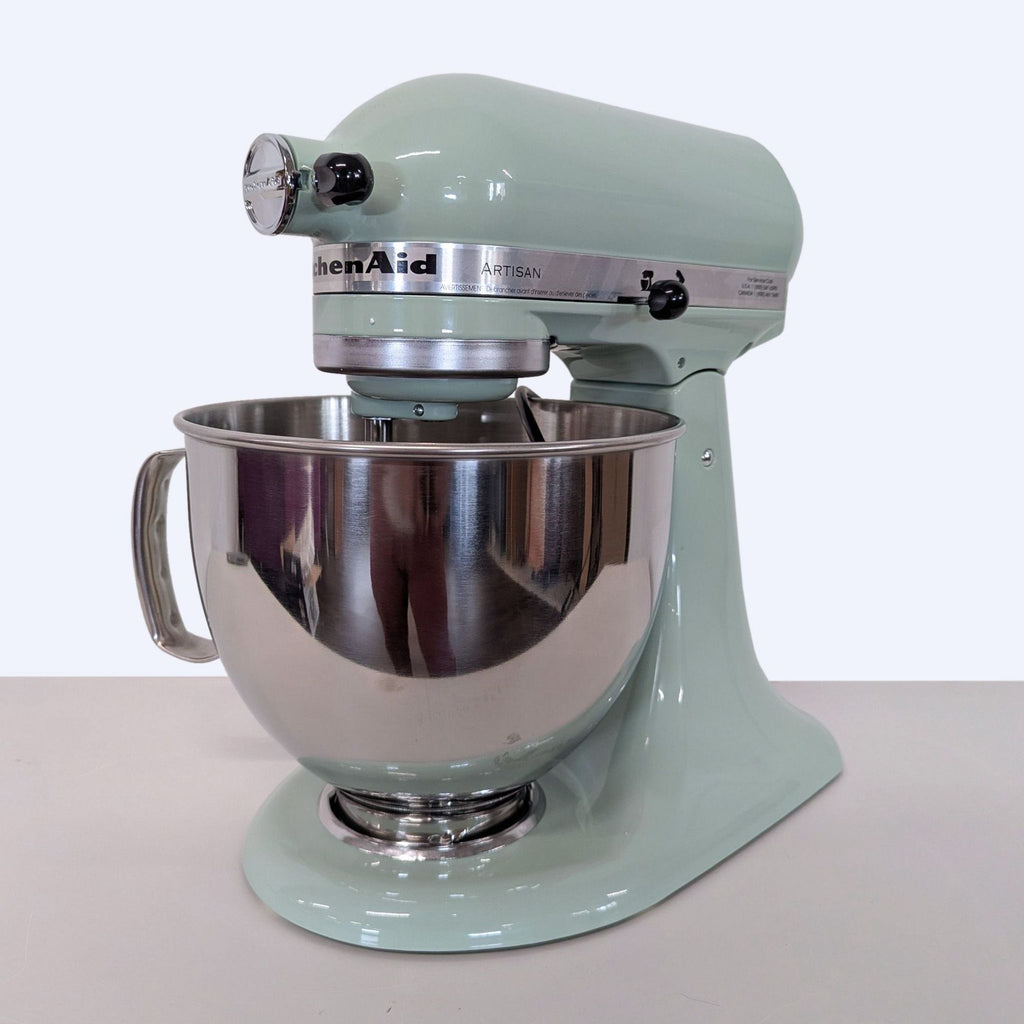KitchenAid stand mixer in mint green, featuring a spacious stainless bowl, perfect for mixing and baking tasks.  