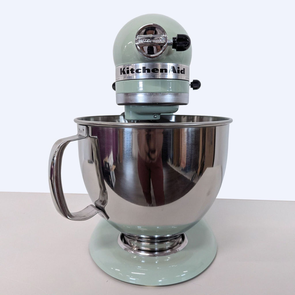 KitchenAid Artisan stand mixer in mint green with large stainless steel bowl and handle, perfect for baking.