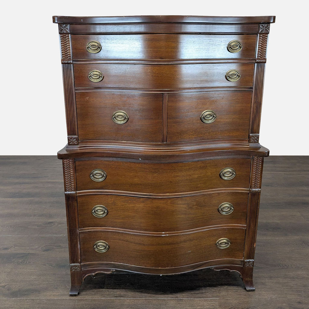 Classic wood dresser with serpentine front, multiple brass-handled drawers, and carved decorative accents.