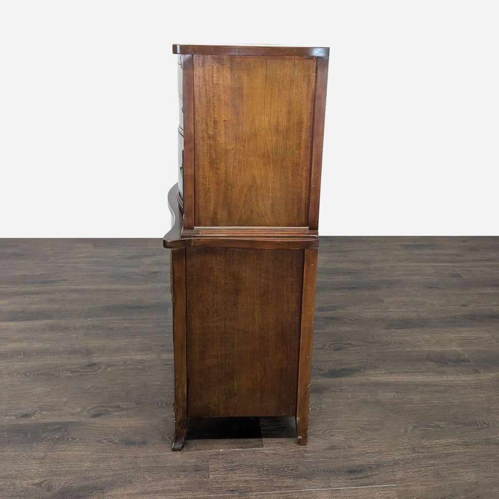 Wooden chest featuring elegant carving, dovetail joints, several drawers, and timeless antique-style design.
