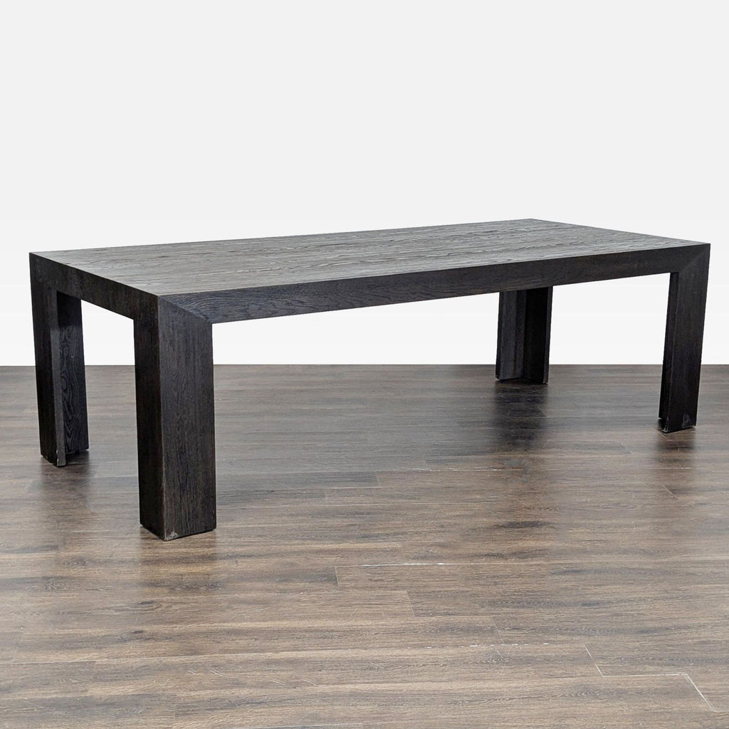 2. Large, rectangular Restoration Hardware dining table with a dark wood finish and modern design.