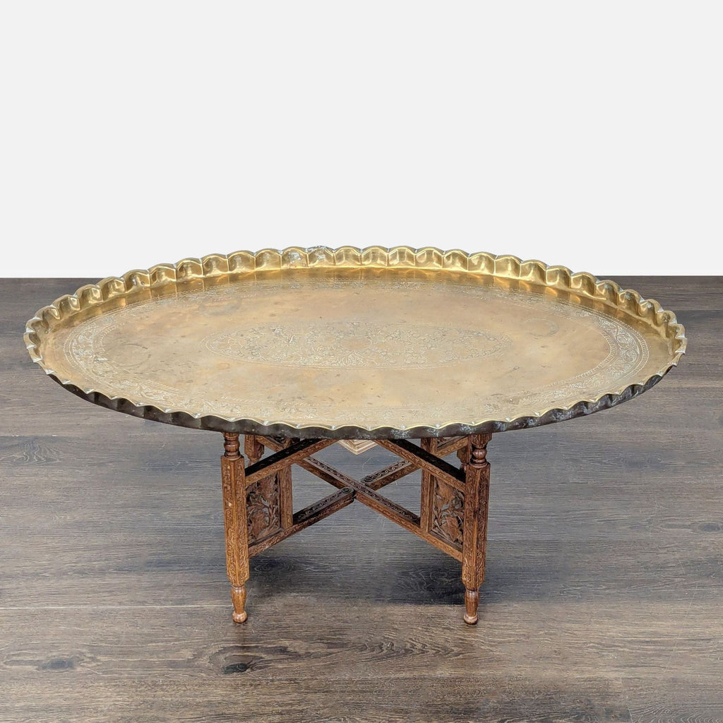 Hand-tooled brass tray top with ornate patterns, removable and set on a collapsible wooden base.