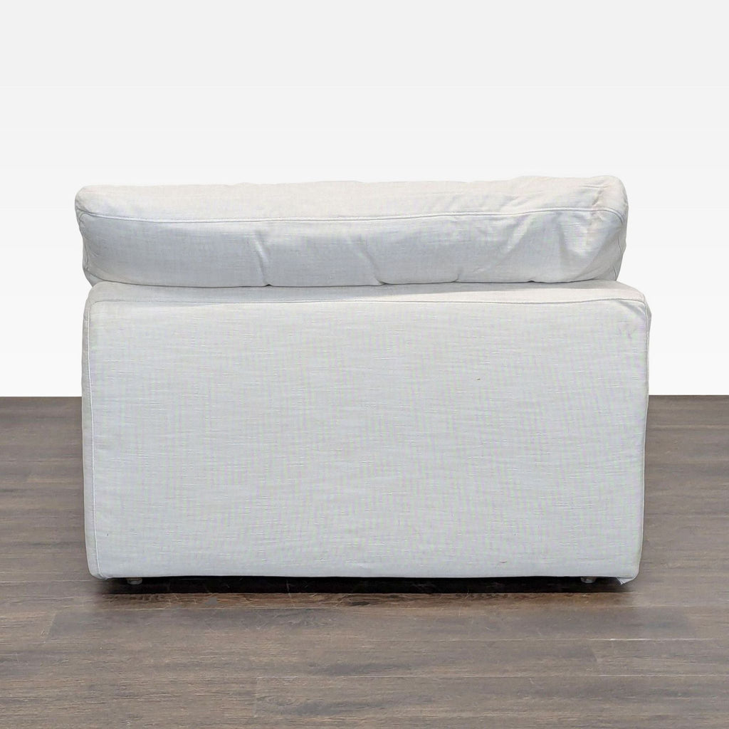 Modern Restoration Hardware sectional chair, armless, with soft linen upholstery and inviting plush cushions.