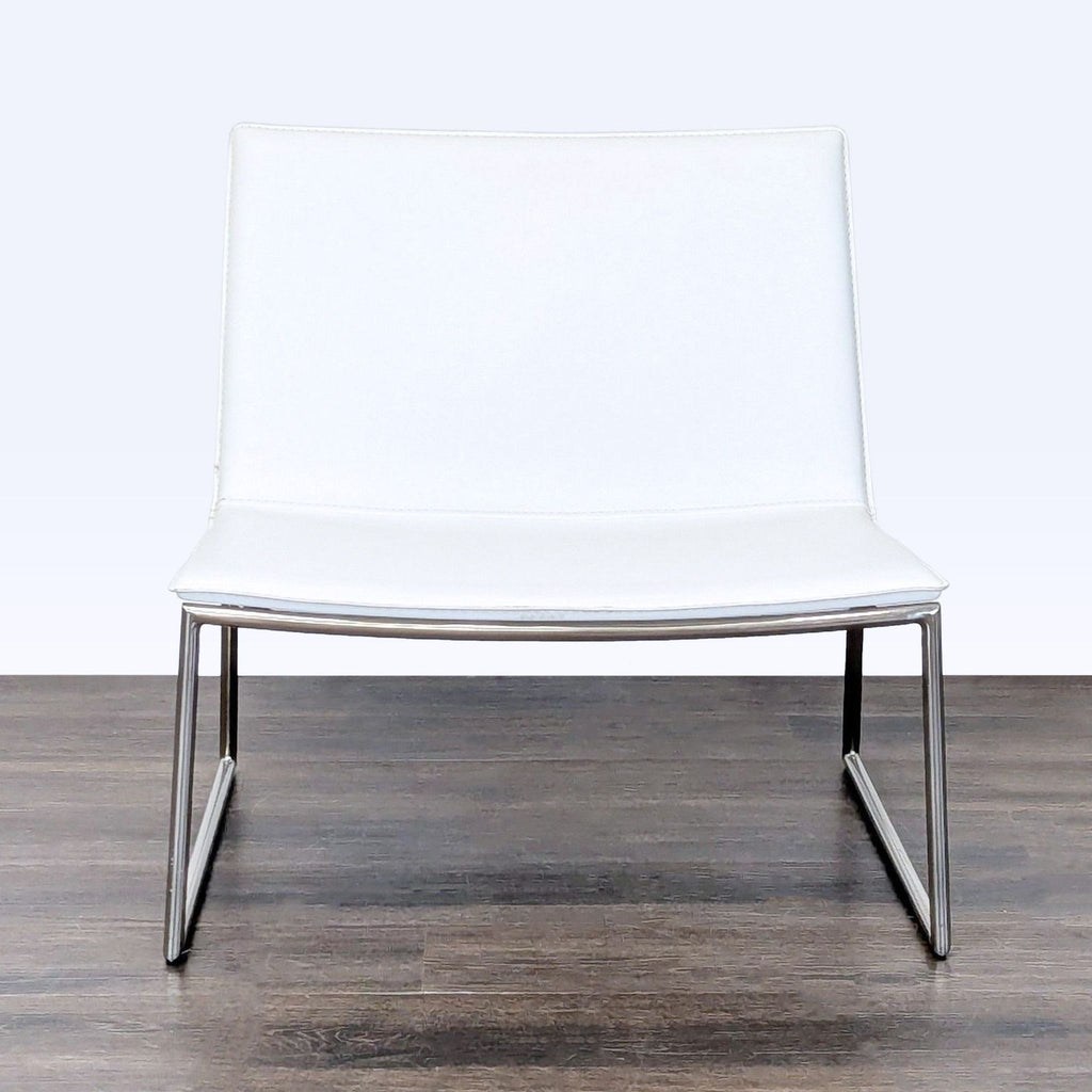 Sleek CB2 lounge chair featuring a white seat, chrome legs, and a contemporary, lightweight design.