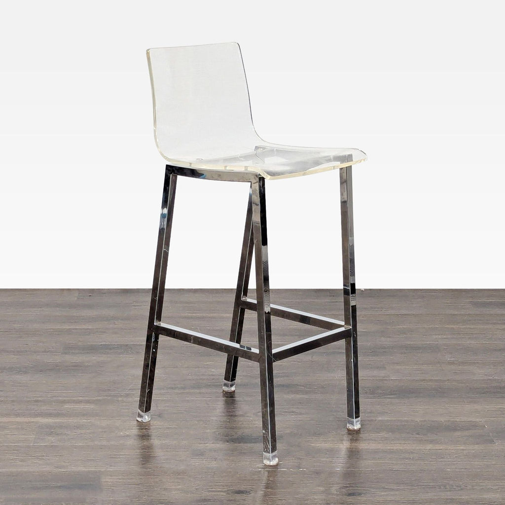 2. Contemporary acrylic stool with a transparent seat and shiny metal frame, angled view, on wood flooring.
