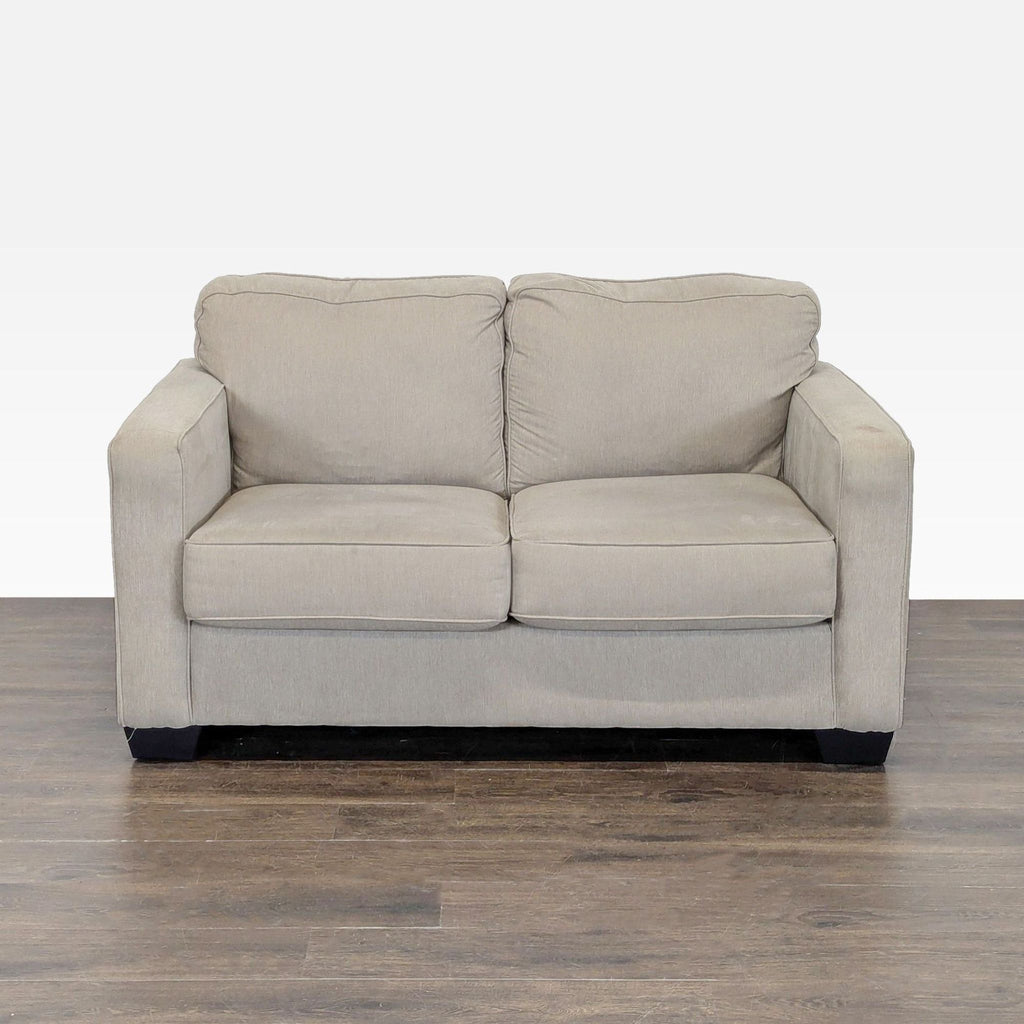 1. Ashley Furniture beige loveseat with soft fabric and modern design, featuring cushioned seat and back.