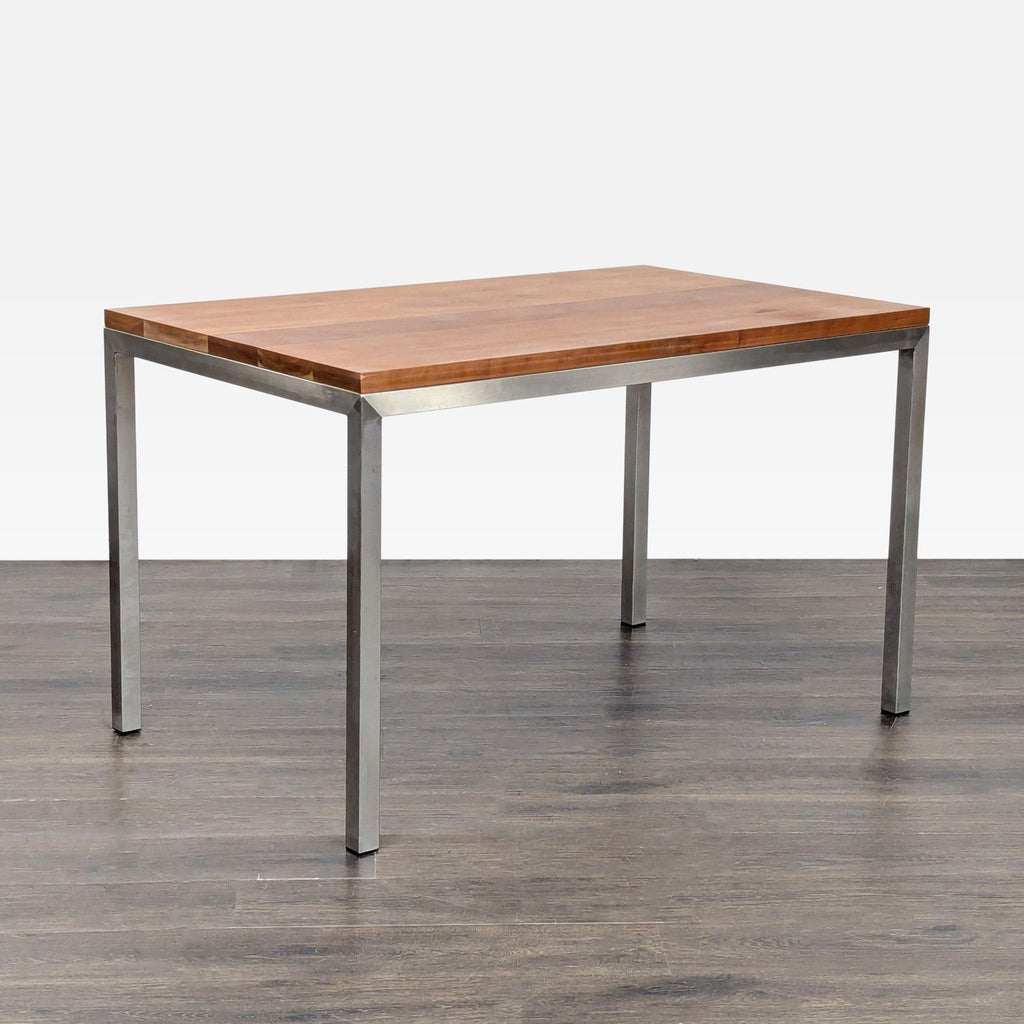 3. Dining table with a natural wood top and square metal legs, angled view on a dark wood floor.