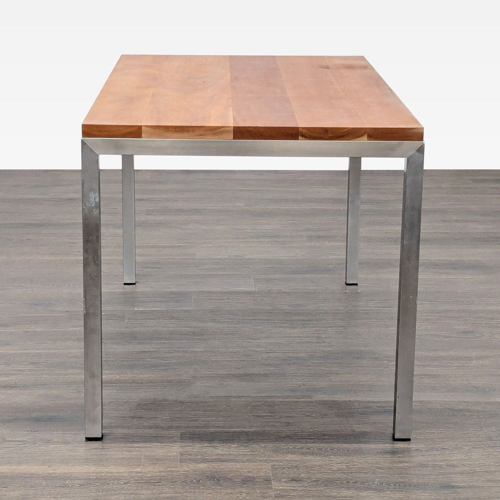 2. Modern dining table with a thick wood surface and straight metal legs, shown from the short end.  