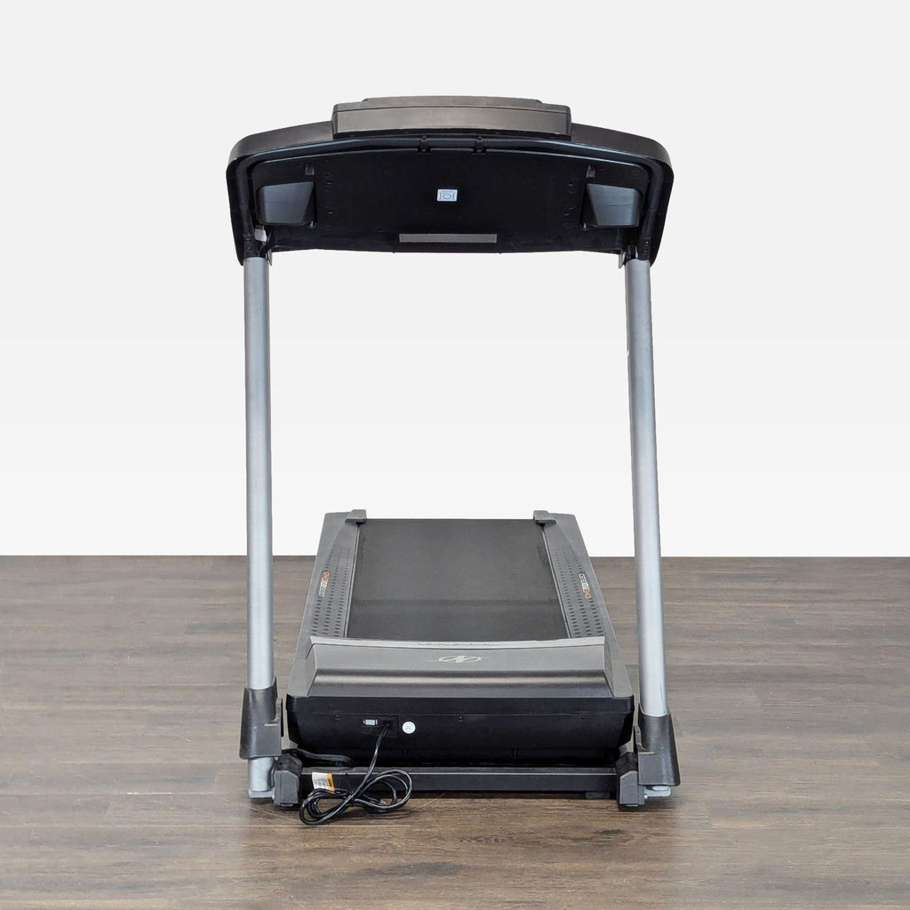 Compact NordicTrack treadmill, perfect for home gyms, shown with power cord and easy-access control panel.