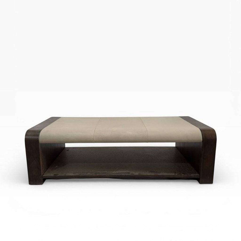 2. Rectangular coffee table by Alder & Tweed, showcasing a leather top and dark wooden sides with a storage shelf below.