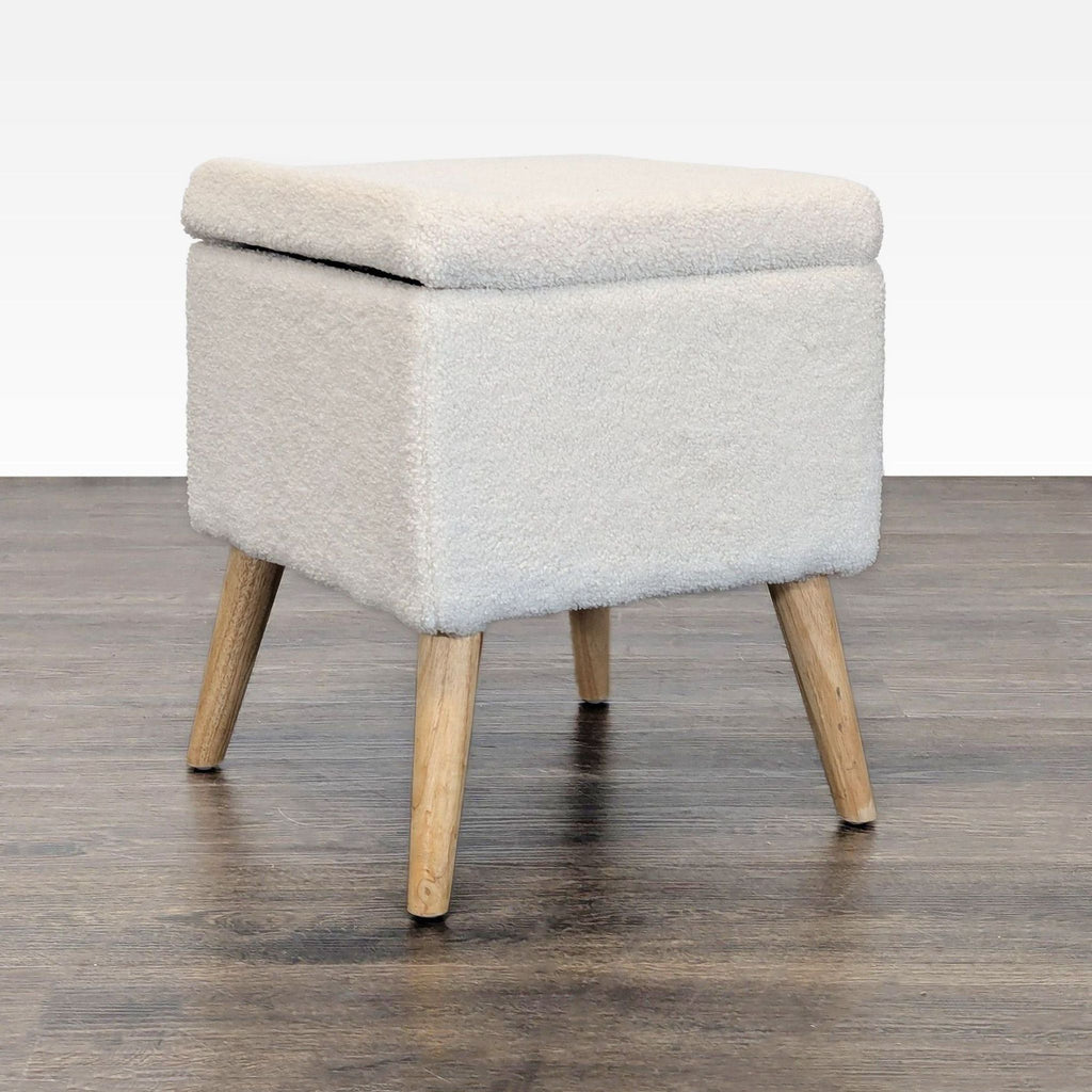 1. Apt2B boucle ottoman with wood legs, perfect for use as a bench or footstool in modern living spaces.  