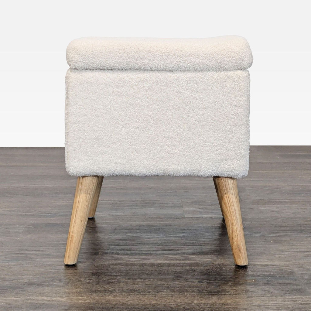 3. Modern Apt2B boucle ottoman on wooden legs, categorized under Stools, Ottomans & Benches.