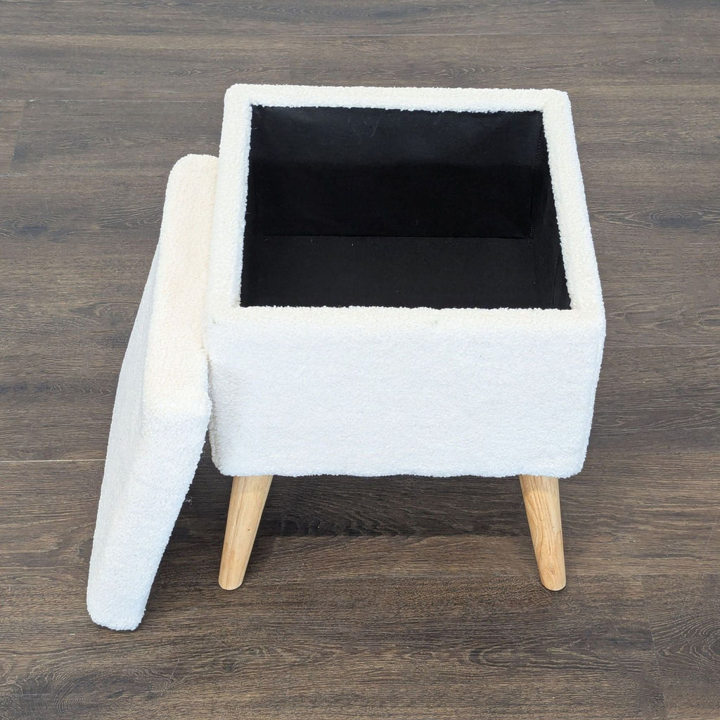 2. Contemporary stool upholstered in boucle fabric, featuring sturdy wood legs; ideal for ottoman or bench use.  