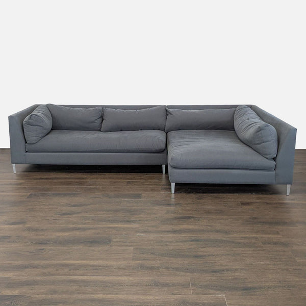 Crate & Barrel gray sectional sofa with plush cushions and metal legs, offering modern style and ample seating.