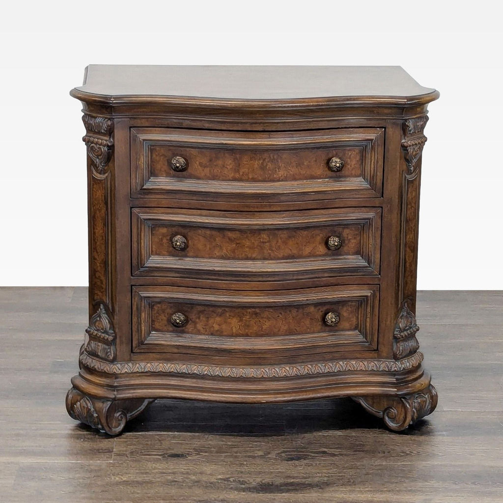 Drexel Heritage end table featuring walnut and burl veneers, serpentine top, and three drawers with brass knobs.  