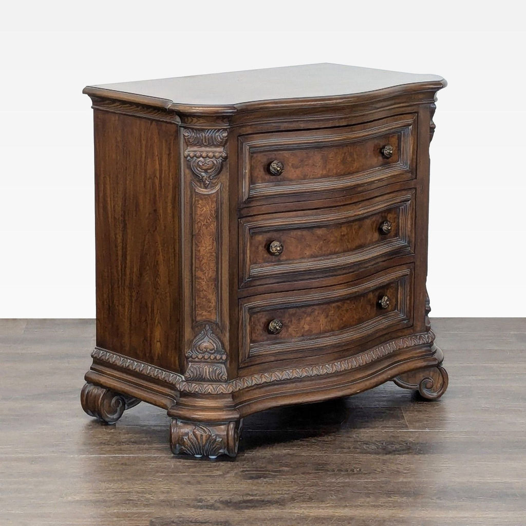 Classic Drexel Heritage nightstand; burl crossbanded top, molded base, carved accents, and dark brass finish hardware.