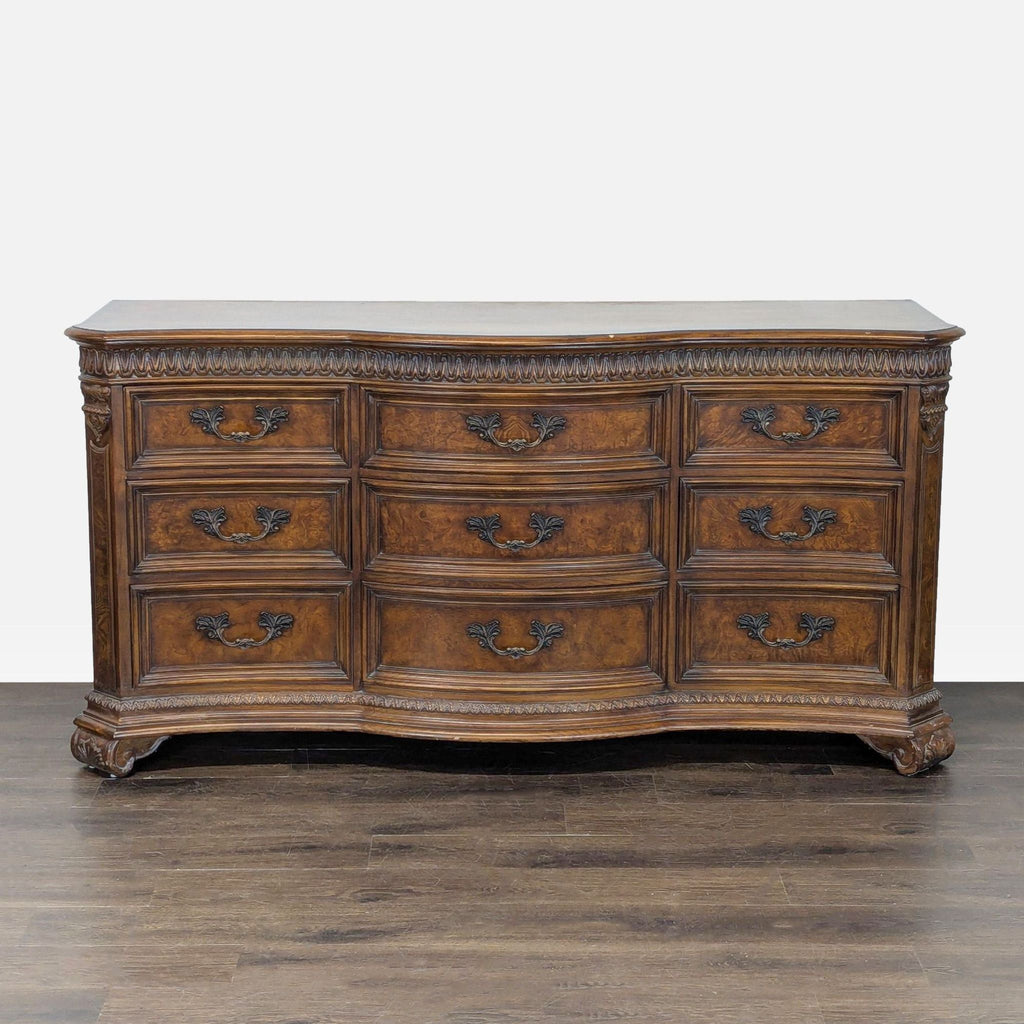 Classic Drexel Heritage dresser with nine drawers, ornate metal handles, and carved wood detailing.  