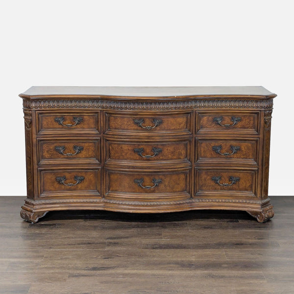 Classic Drexel Heritage dresser with nine drawers, ornate metal handles, and carved wood detailing.  