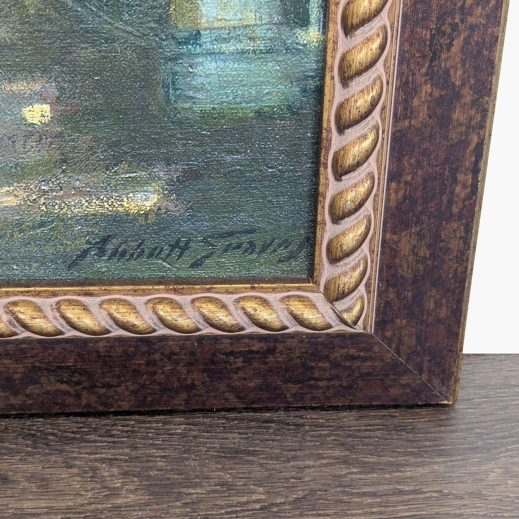 2. Close-up of the HomeGoods print’s decorative brown and gold frame, highlighting the artist's signature.