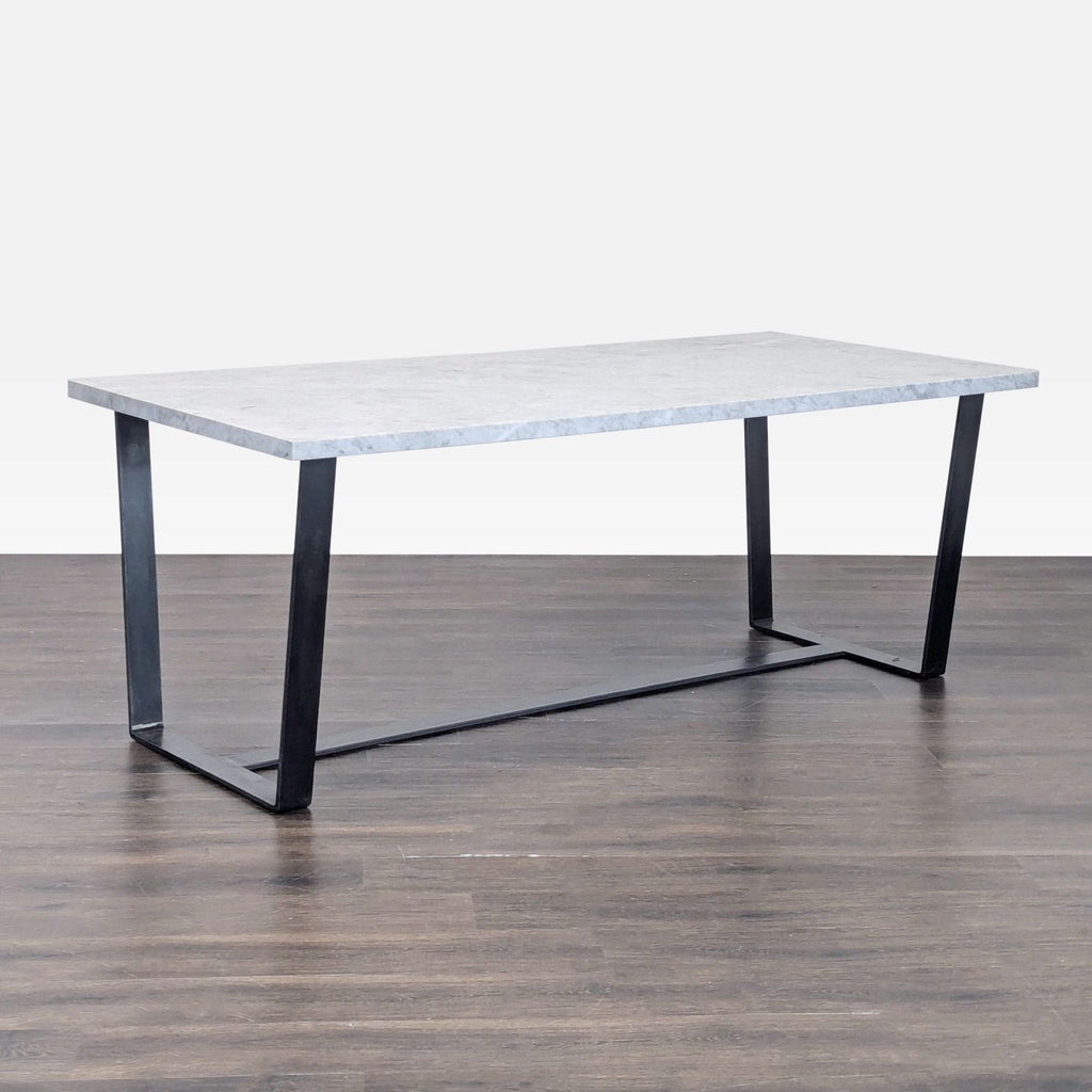 2. Rectangular marble dining table for eight, supported by a black steel trestle sled base.  