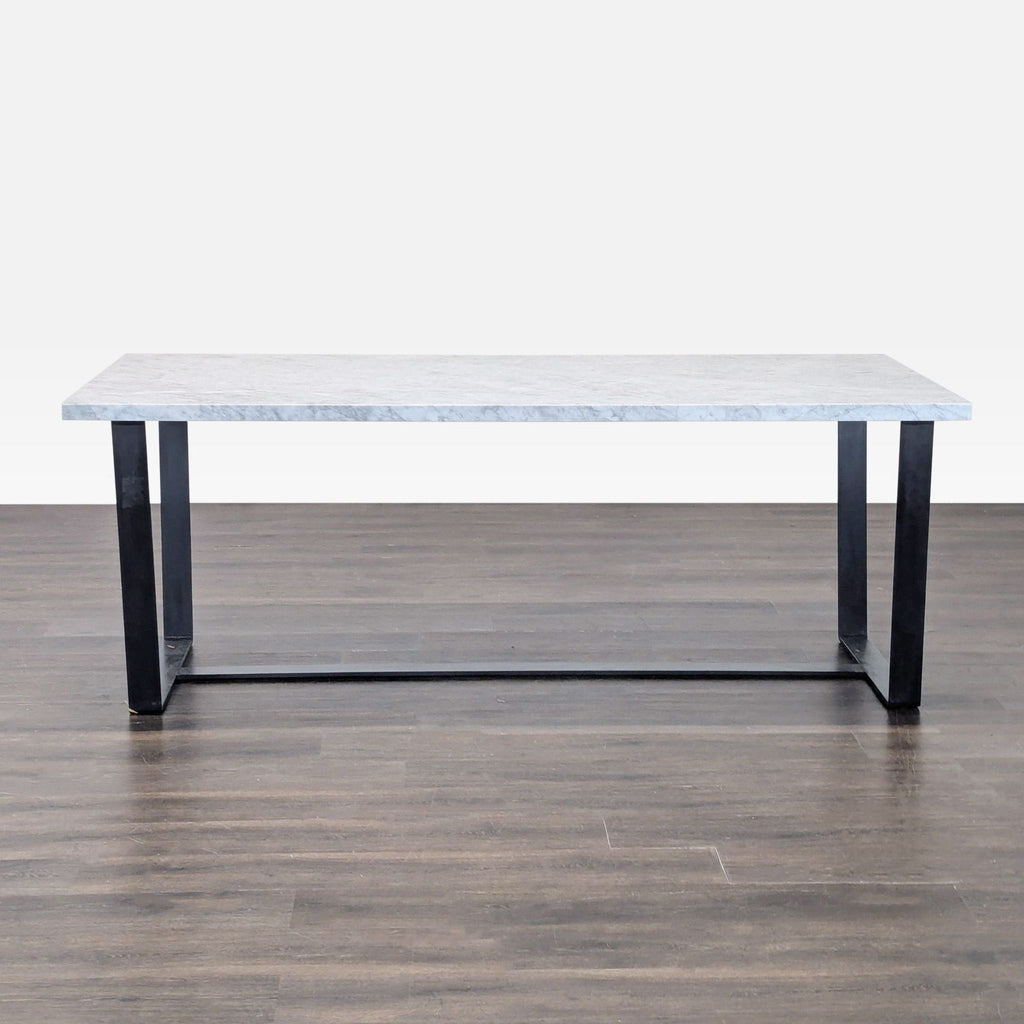1. Modern eight-seater dining table with a marble top and blackened steel sled base on wooden flooring.  