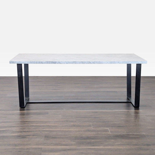 1. Modern eight-seater dining table with a marble top and blackened steel sled base on wooden flooring.  
