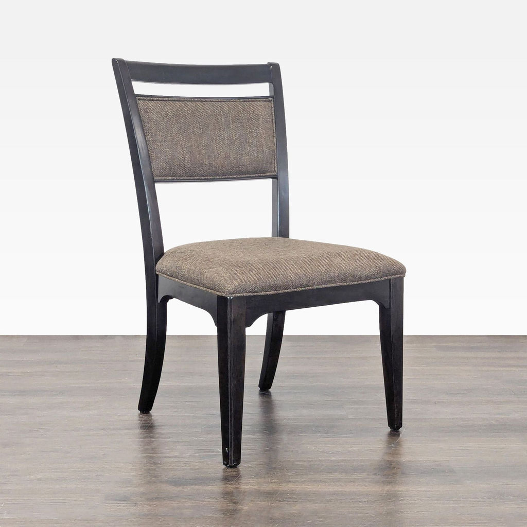 3. Modern upholstered chair by Universal Furniture, showing padded back and seating area.