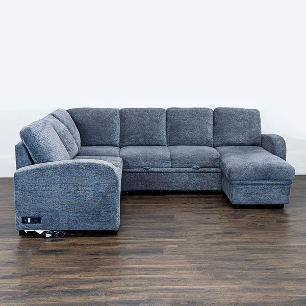 Gray Lifestyle Solutions sectional with chaise lounge, padded cushions, and built-in power outlet for charging devices.
