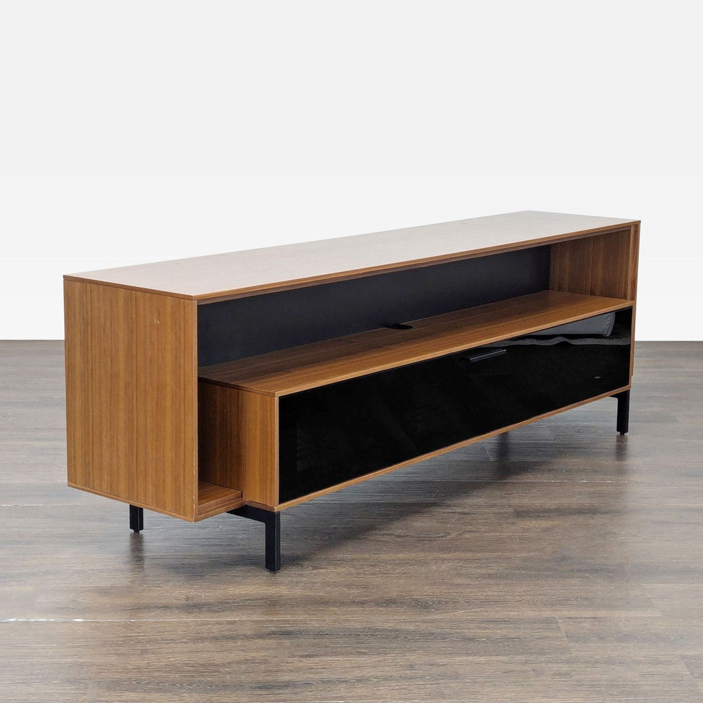 3. Angled view of BDI entertainment center, highlighting walnut finish, open shelf, black glass front, and ample storage.